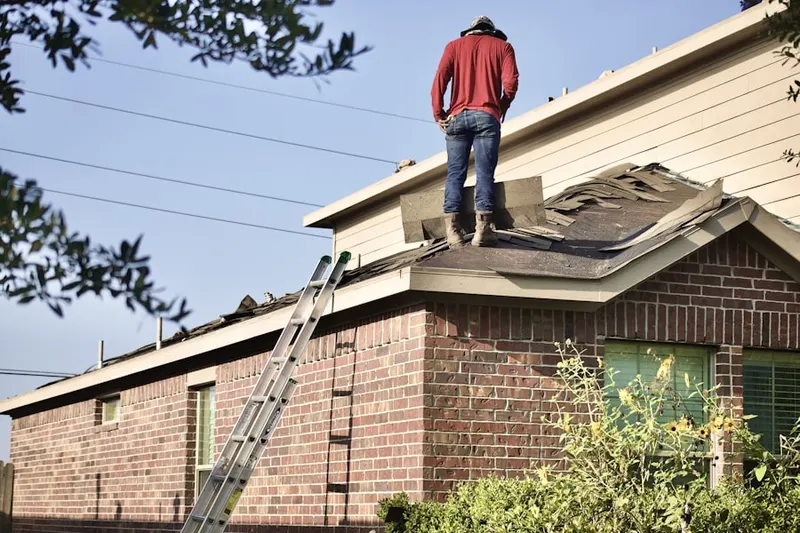 Professional roofer working on a residential roof in Indian Field